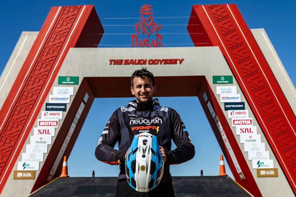 Piloto argentino ajustando su KTM 450 Rally en el desierto, con casa rodante y equipo modesto a sus espaldas