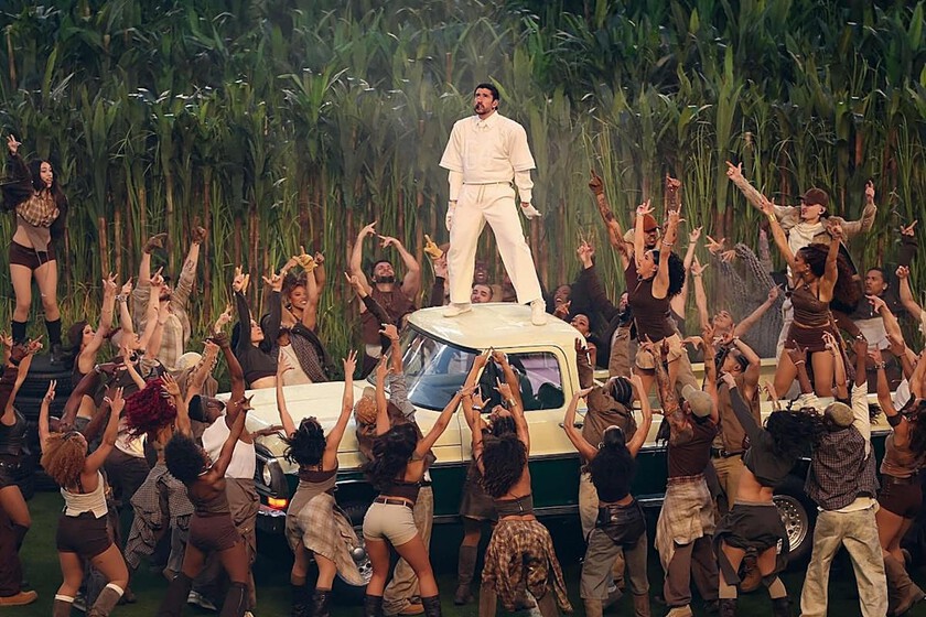 Bad Bunny en el escenario del Super Bowl 2026 con fondo de caña de azúcar y la frase 'The only thing more powerful than hate is love' iluminada