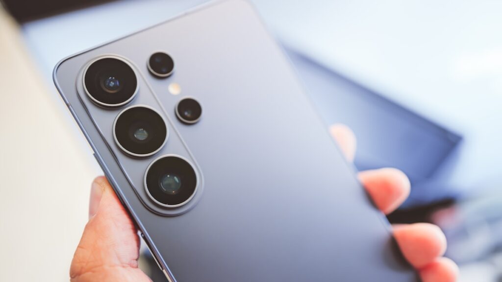 Galaxy S26 Ultra en mano mostrando su módulo de cámaras y pantalla de 6,9' con reflejos