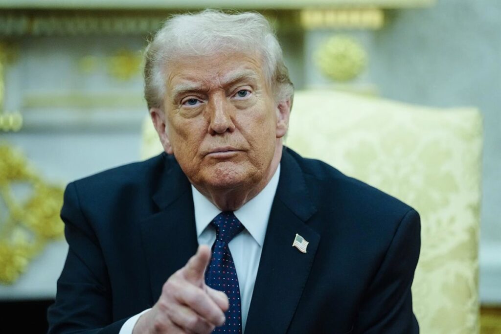 Donald Trump señala a la OTAN en un mapa del estrecho de Ormuz con barcos militares y banderas de EE.UU. e Irán