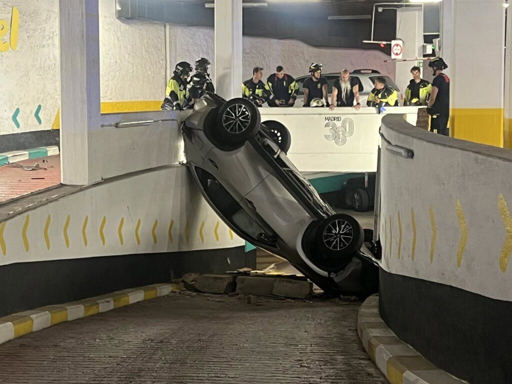 Coche destrozado boca abajo tras caer entre plantas en parking con fallos estructurales en Madrid