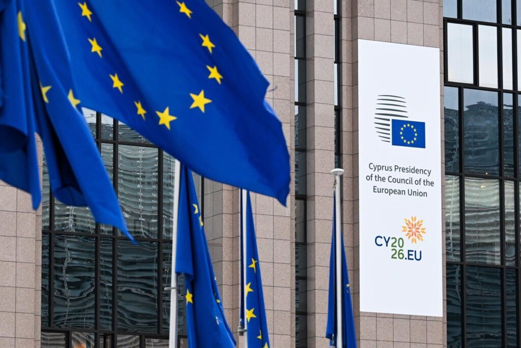 Firma simbólica del acuerdo UE-EEUU con banderas de ambos bloques y gráficos de productos liberados como whisky y queso