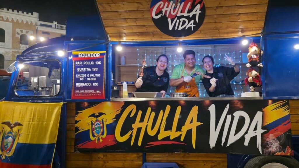 Diana Lozano sonríe junto a su food truck Chulla Vida decorado con colores de Ecuador