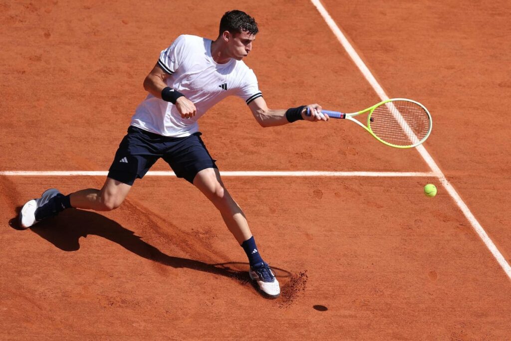 Juan Manuel Cerúndolo celebra su victoria épica sobre Jannik Sinner en Roland Garros 2025 con puño alzado en cancha central